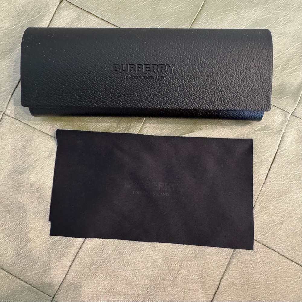 Authentic BURBERRY black hardshell eyeglasses case and branded lens cloth.
